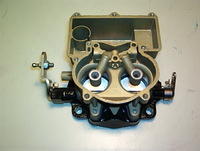 This is the inside of the Carburetor Main Body.  You can see the assembled Ventury Cluster, New Attaching Hardware, Fuel Bowl, Accelerator Bore, BasePlate and attaching Hardware, Levers, and etc.